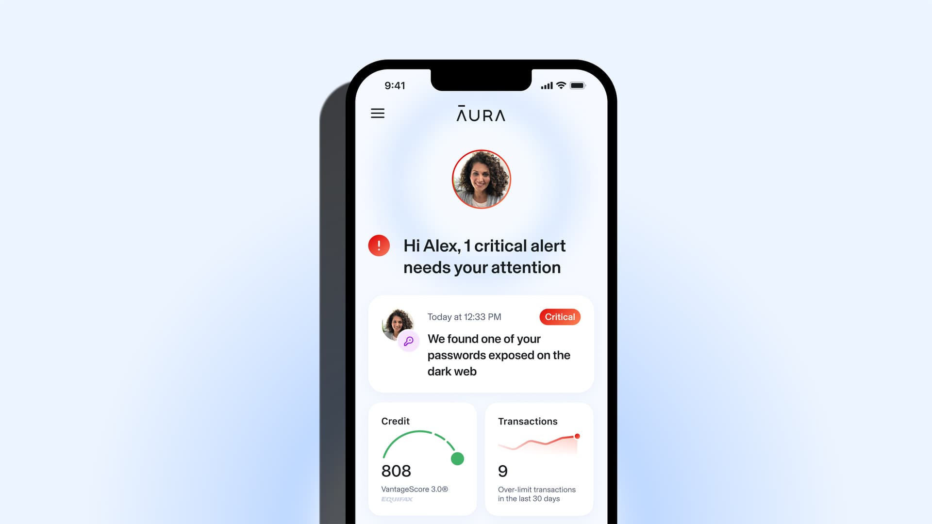 Close-up of the Aura mobile app showing a real-time security alert on a smartphone